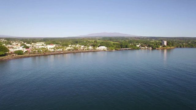 Aerial reveal of downtown Hilo with a clear Mauna Kea in the background