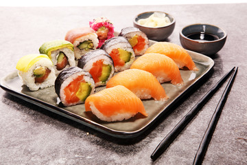 close up of sashimi sushi set with chopsticks and soy - sushi roll with salmon and sushi roll with smoked eel