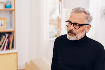 Pensive senior man wearing glasses