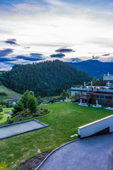Alpe di Siusi, Seiser Alm with Sassolungo Langkofel Dolomite, a large green field with trees in the background