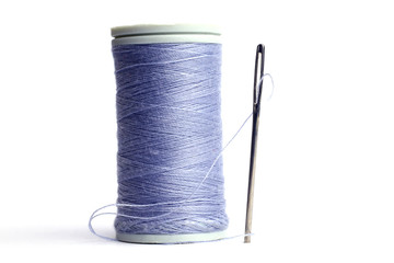 Spool of thread with needle.