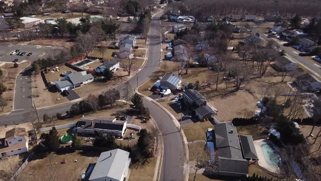 Drone ascending over housing road  and homes