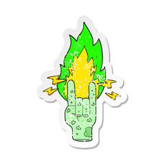 retro distressed sticker of a cartoon zombie hand making horn sign