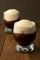 Coffee affogato with vanilla ice cream and espresso. Glass with coffee drink and icecream.