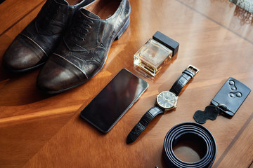 different accessories of a businessman for creating a style of a people lie on a wooden background