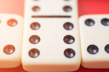 Dominoes on red table