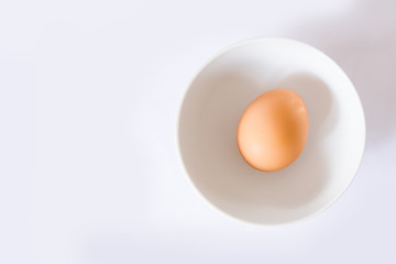 whole egg  with egg shells in a bowl with white background