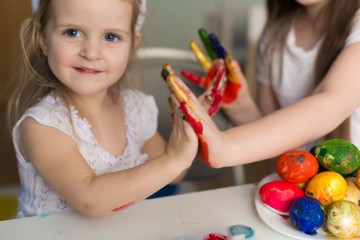  Girls paint easter eggs