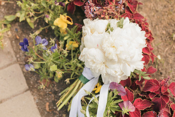 White wedding bouquet in the hands of the bride