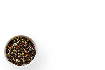 rainbow whole peppercorns red pink green black white on a white background with round bowl