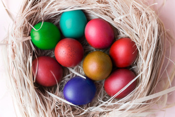  lots of colorful boiled Easter eggs in the nest