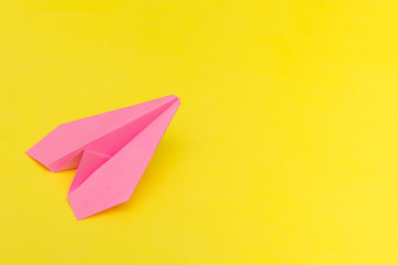Red paper plane on yellow background, minimal creative concept