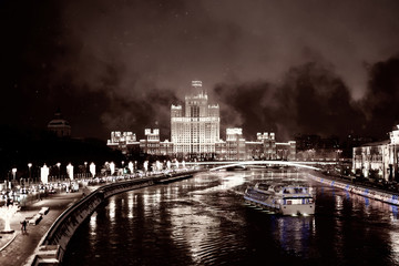 Fototapeta premium Tourist steamboat on Moscow river, view of night city lights on embankment 