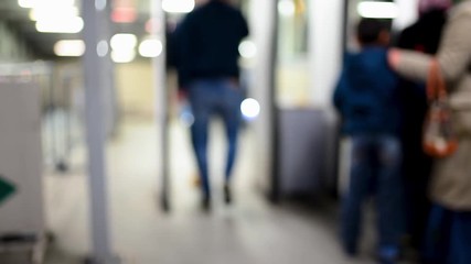 People pass through a metal detector at the entrance to metro.Blurred Defocused video
