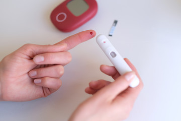 Woman sick on diabetes, is checking her glucose level.