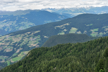 Fototapeta premium Alpe di Siusi, Seiser Alm with Sassolungo Langkofel Dolomite, a view of a large mountain in the background