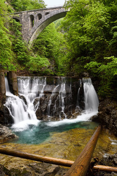 Single Arch Stone Bridge For Bohinj Railway Over The Radovna River Valley At Vintgar Gorge With Logs And Waterfalls At Dam Sluice Gate Slovenia