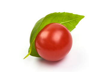 Basil with ripe cherry tomato, close-up, isolated on white background