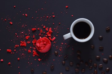 Coffee composition. White Cup of fragrant coffee on a background of red pieces of biscuits 