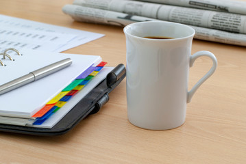 coffee cup standing on the office desk