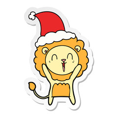 laughing lion sticker cartoon of a wearing santa hat