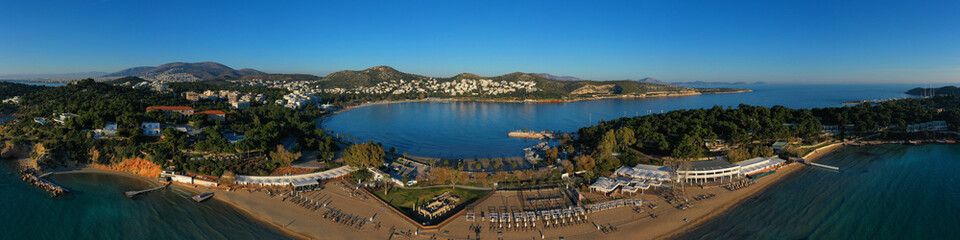 Fototapeta na wymiar Aerial drone photo of iconic turquoise sandy celebrity beach of Asteras or Astir and ancient temple of Apollo Zoster, Vouliagmeni, Athens riviera, Attica, Greece