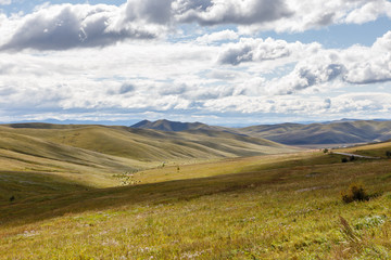 Mongolian steppe on the background of a cloudy sky, beautiful landscape. Mongolia