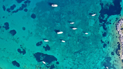 Aerial drone bird's eye photo of traditional fishing boat in island of Mykonos, Cyclades, Greece