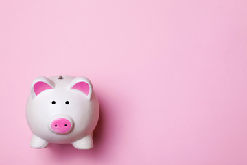 White piggy bank isolated on pink. Money saving background.