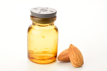 Almond oil in bottle isolated on white background, macro