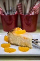 Evening table and sweet concept . Birthday Party Piece of Homemade Cheescake with Tangerines on white Plate