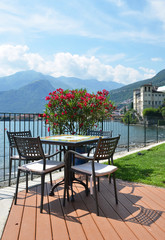 Table in a cafe against Como lake - 253389320