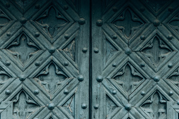 Green wooden doors texture with gothic elements