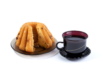 Rum Baba with a cup of tea on a white background