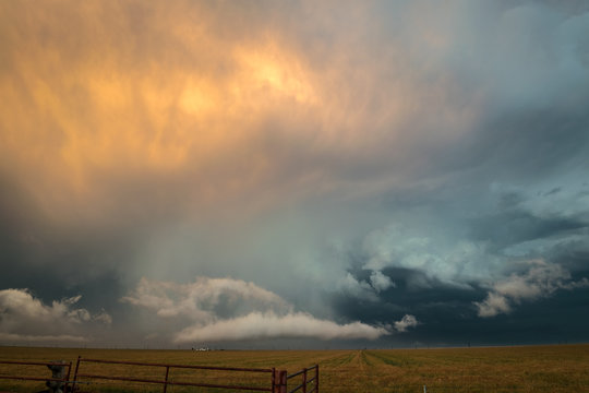 Beautiful orange and blue colors at the back of a Texas severe thunderstorm. Amazing colors at sunset time when a thunderstorm moves away from the photographer. - Powered by Adobe