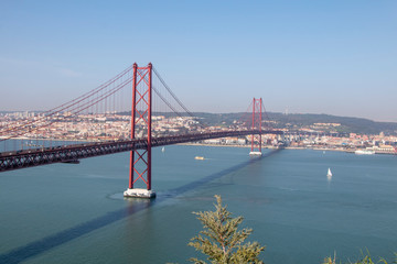beautiful red rope bridge across the river in lisbon