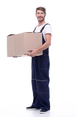 man in a jumpsuit holding a large box