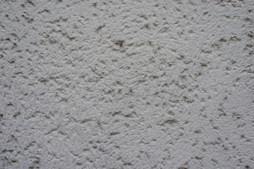 Graue Wand mit Rohputz