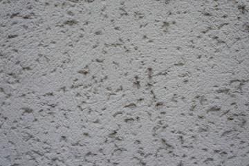 Graue Wand mit Rohputz