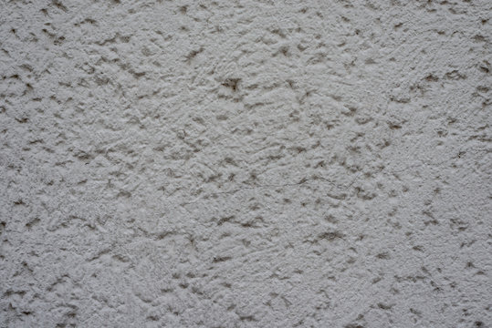 Graue Wand mit Rohputz