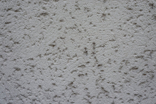 Graue Wand mit Rohputz