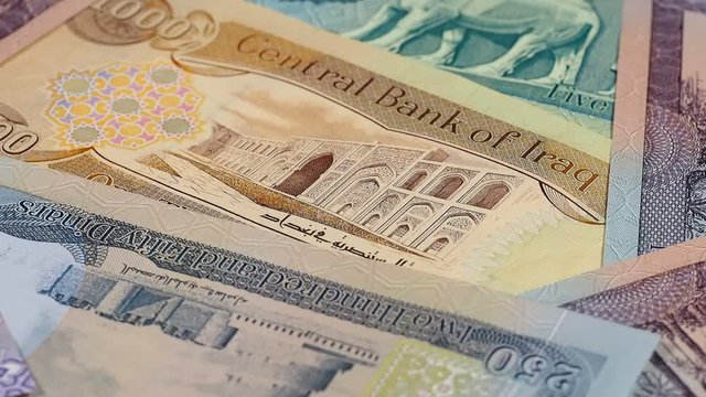Iraq currency dinar notes rotating. Iraqi money, economy, investment. Low angle. Stock video footage