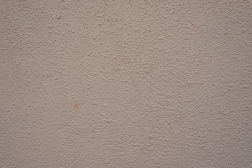 Feine Wand mit Creme-Farbe gestrichen und kontrastarm