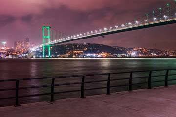 Istanbul Bosphorus Bridge (15th July Martyrs Bridge) with green light. Istanbul, Turkey..