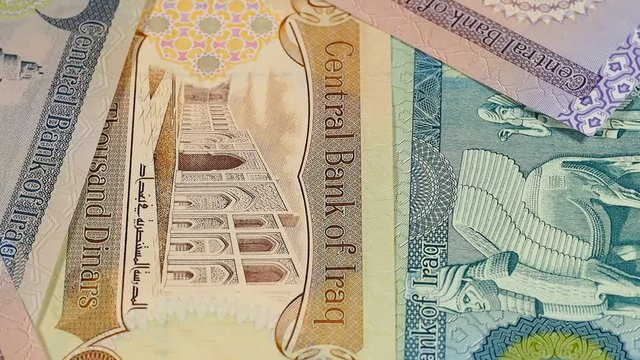 Iraq currency dinar notes rotating. Iraqi money. Low angle. Stock video footage