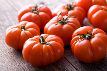 Natural fresh tomatoes on the wood.