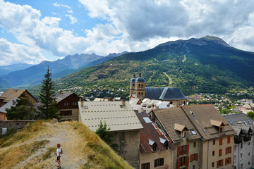 Fototapeta na wymiar View of the Collegiate Church of Notre-Dame and Saint-Nicolas and rooftop of Old Town in Briancon, Province, France