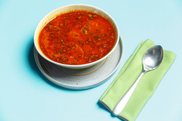A plate of delicious soup. blue background.