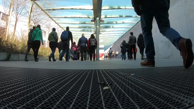 many pedestrians walking by with luggage to a outdoor fair, munich