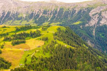 Obraz premium Alpe di Siusi, Seiser Alm with Sassolungo Langkofel Dolomite, a large green field with a mountain in the background